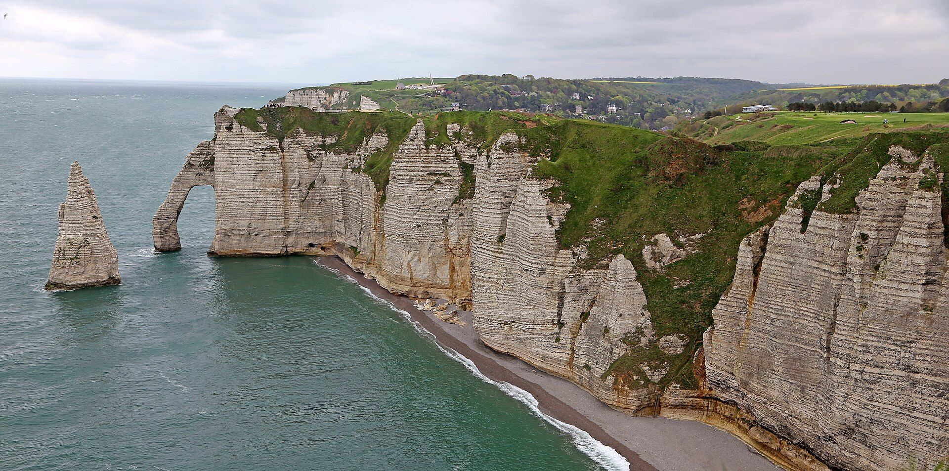 The Aiguille needle and Porte d'Aval arch beside the white chalk cliffs of Étretat, Normandy