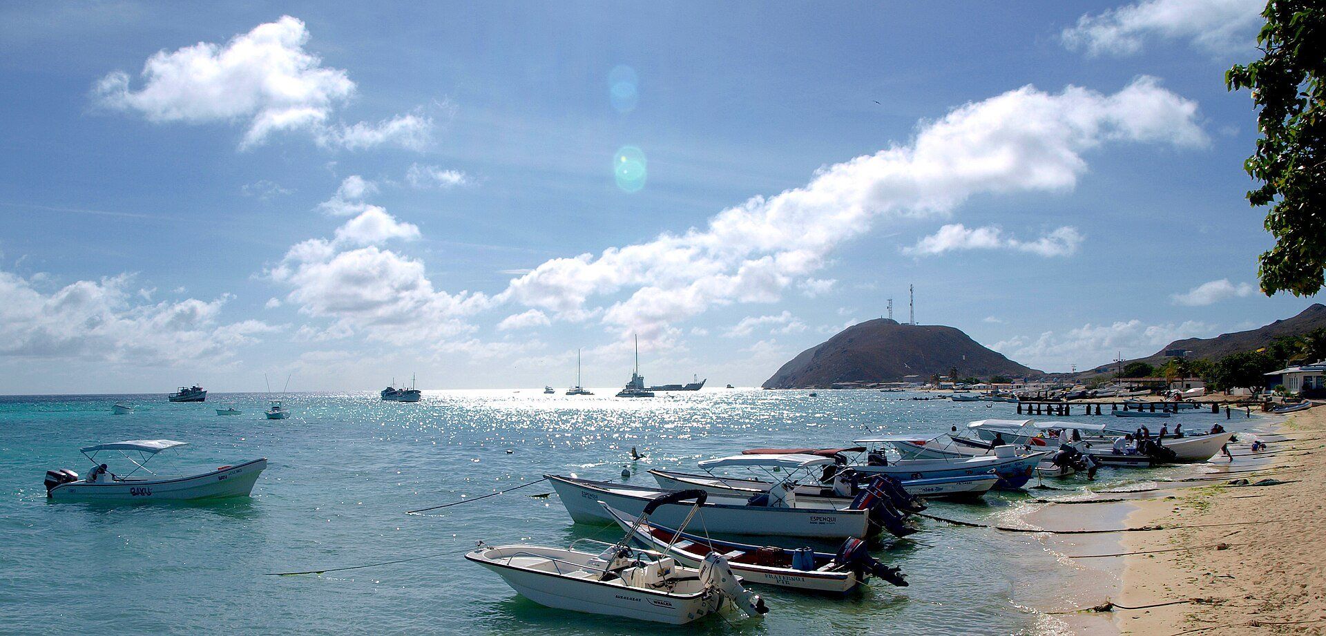 Boats moored off the beach at Gran Roque in the Los Roques Archipelago, Venezuela, with the island's hill behind