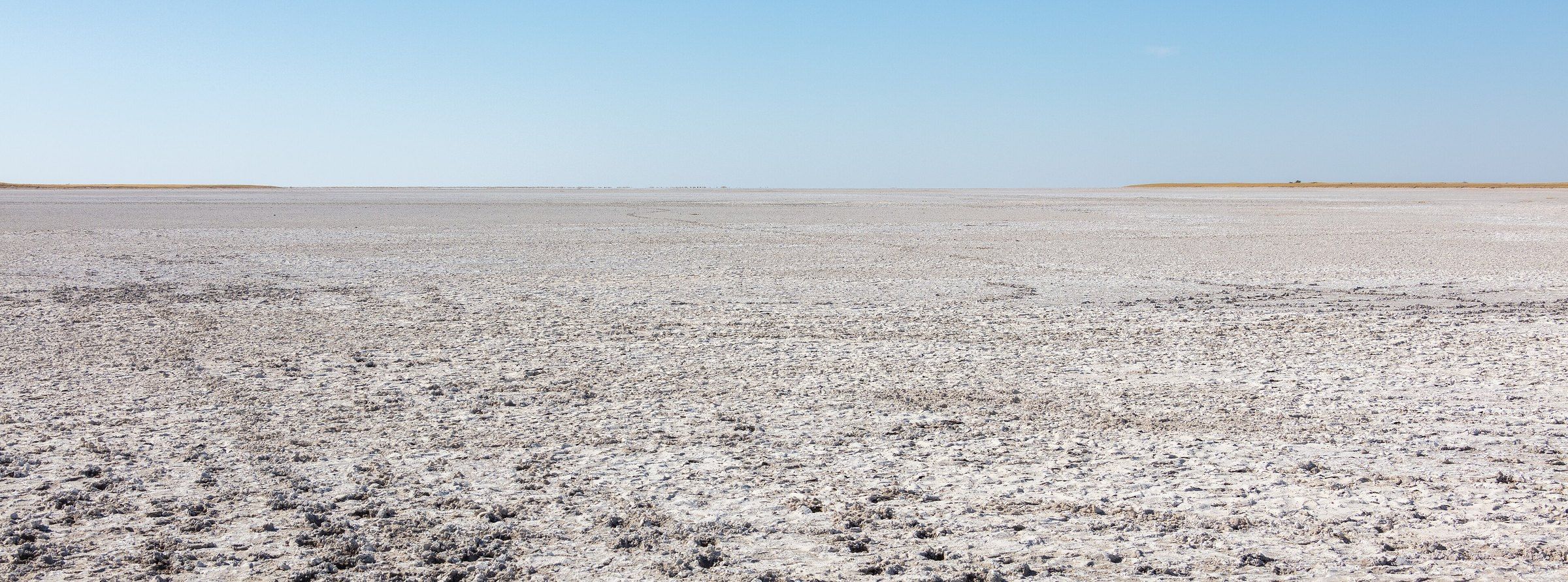 Flat white salt crust of the Makgadikgadi Pans stretching to the horizon, Botswana