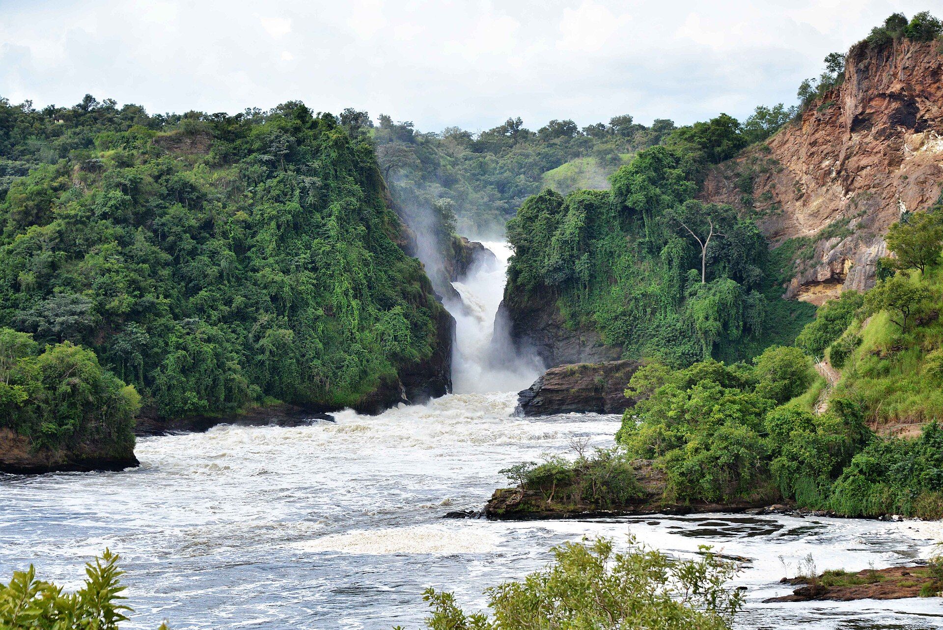 The Nile bursting through a narrow gorge at Murchison Falls between forested cliffs, Uganda