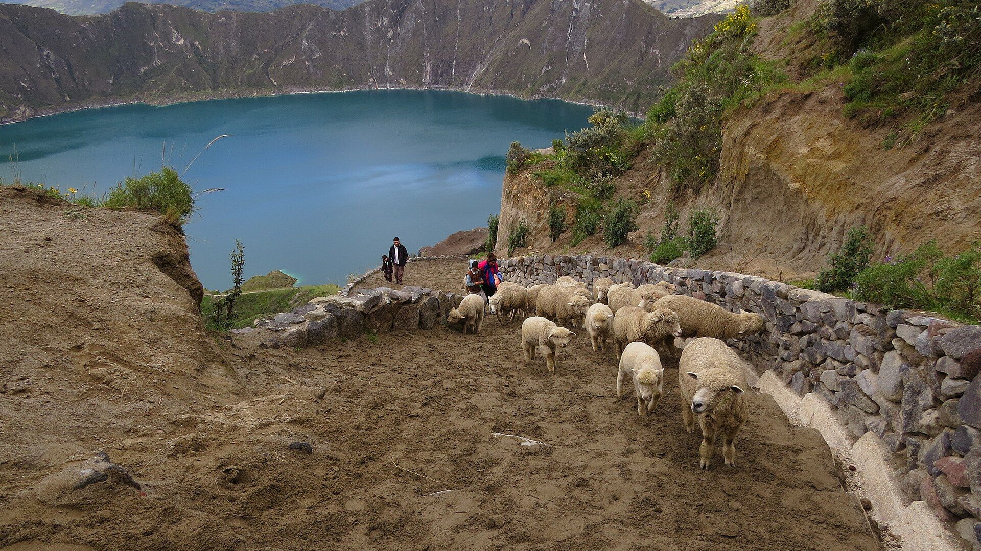 Green Quilotoa crater lake inside its caldera, seen from the path down from the rim, Ecuador